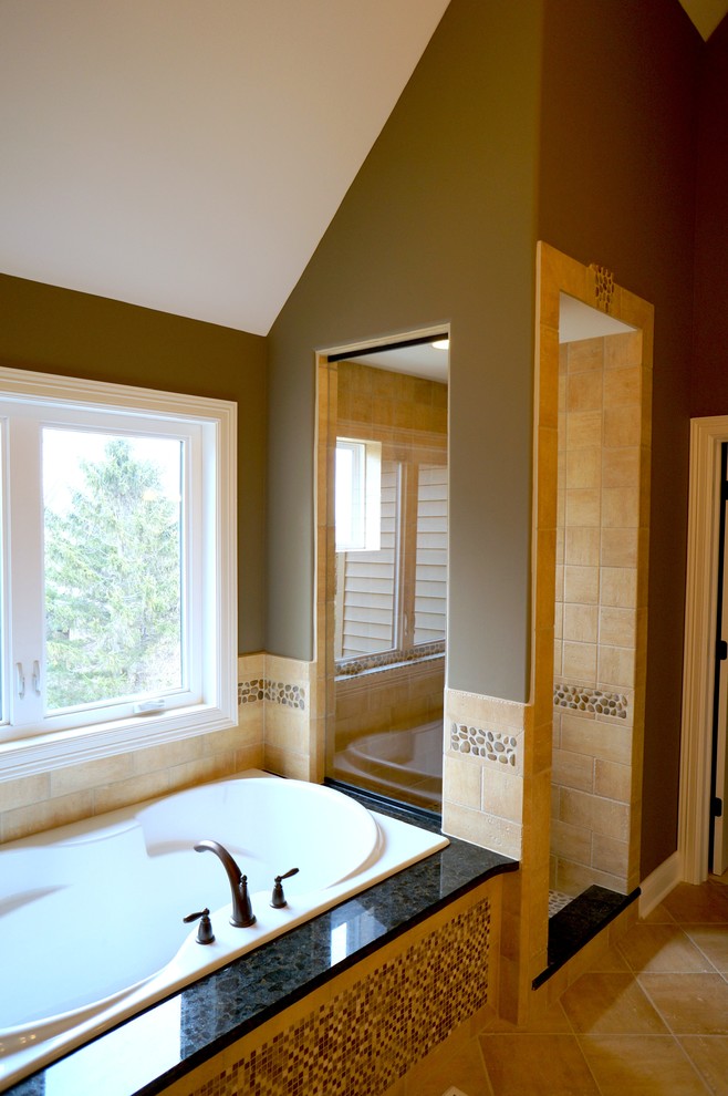 This is an example of a large rustic ensuite bathroom in Chicago with a pedestal sink, dark wood cabinets, granite worktops, a one-piece toilet, beige tiles, ceramic tiles, grey walls, ceramic flooring and a built-in bath.