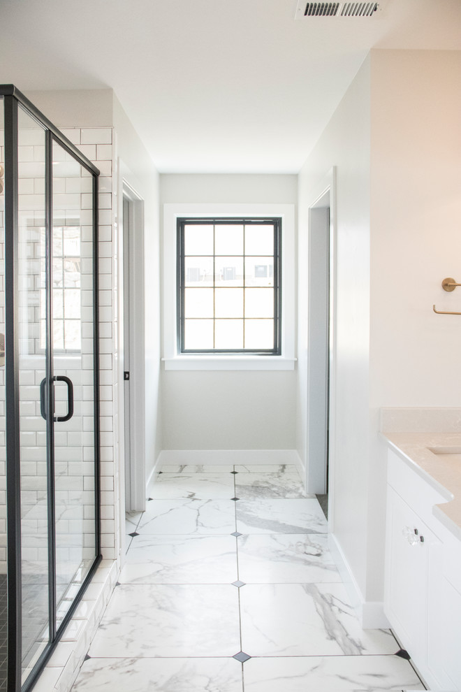Example of a mid-sized cottage master white tile and ceramic tile ceramic tile and white floor bathroom design in Salt Lake City with shaker cabinets, black cabinets, gray walls, an undermount sink, quartz countertops, a hinged shower door and white countertops