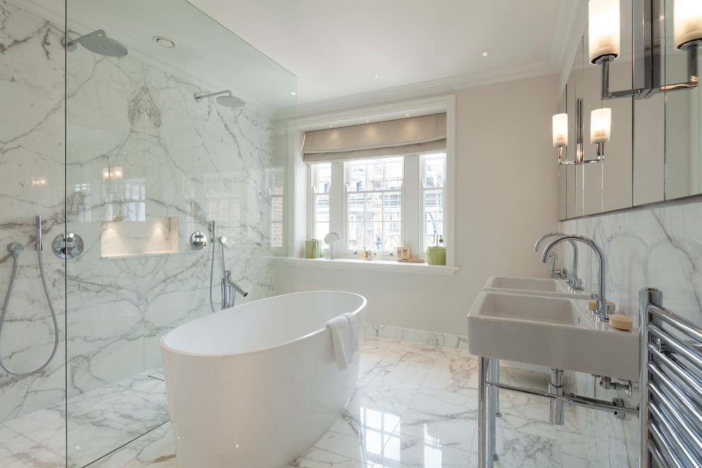 Modernes Badezimmer mit freistehender Badewanne, Doppeldusche, weißen Fliesen, beiger Wandfarbe und Waschtischkonsole in London