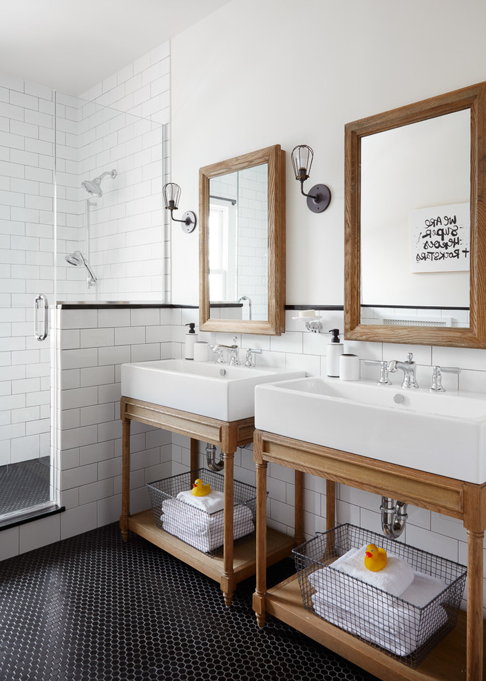 Example of a danish master black tile, white tile and subway tile mosaic tile floor and black floor corner shower design in Chicago with white walls, a console sink and a hinged shower door