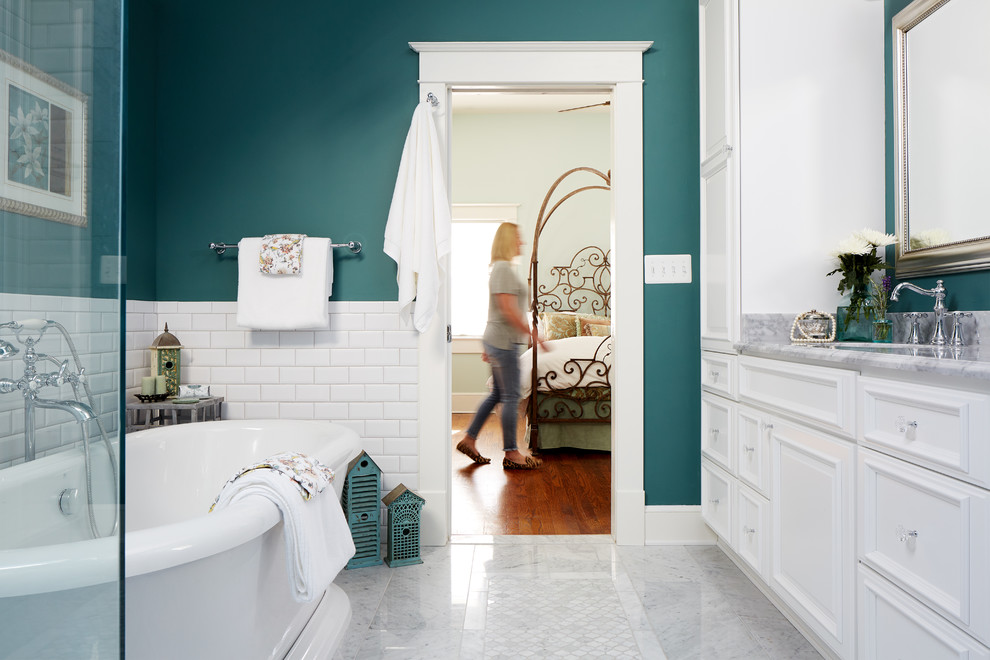 Example of a mid-sized classic master white tile and ceramic tile marble floor and gray floor bathroom design in Chicago with raised-panel cabinets, white cabinets, a one-piece toilet, green walls, an undermount sink, marble countertops, a hinged shower door and gray countertops
