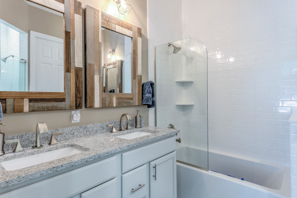 Inspiration for a mid-sized coastal 3/4 white tile and subway tile bathroom remodel in Other with recessed-panel cabinets, white cabinets, beige walls, an undermount sink, granite countertops and multicolored countertops