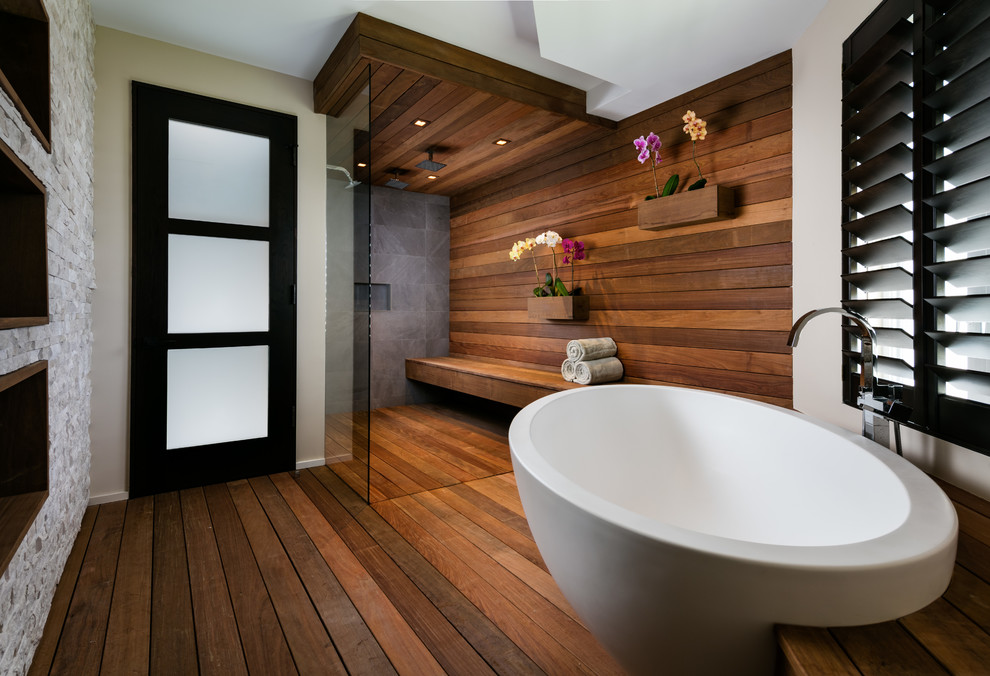 Large trendy master dark wood floor and brown floor bathroom photo in Miami with beige walls, a vessel sink and wood countertops