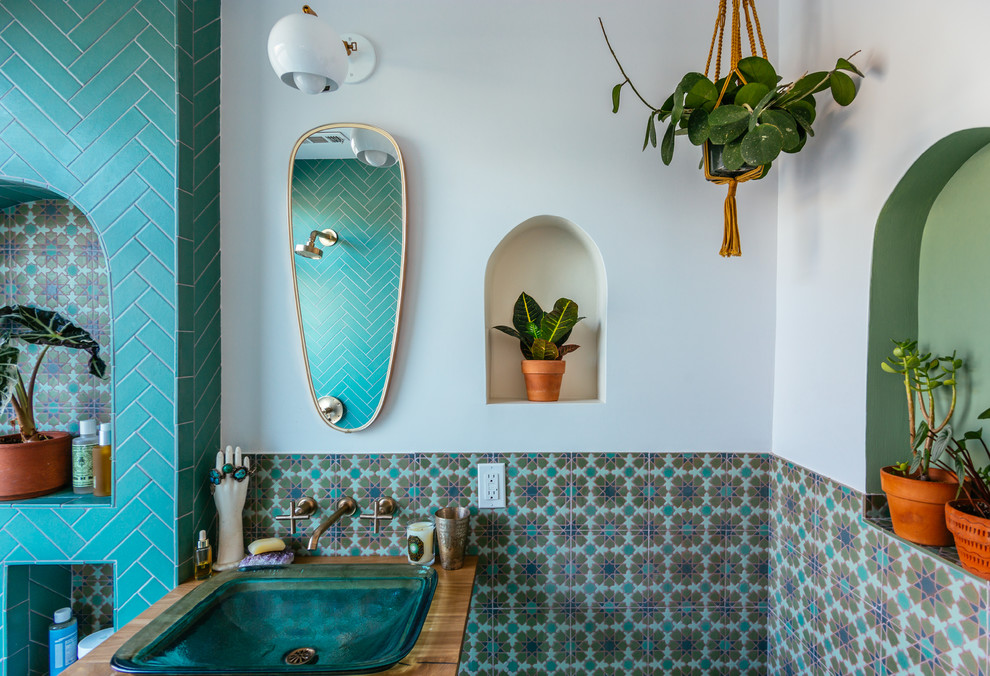 Photo of a mediterranean bathroom in San Francisco with a shower/bath combination, green tiles, ceramic tiles, white walls, ceramic flooring, a pedestal sink, wooden worktops, green floors and an open shower.
