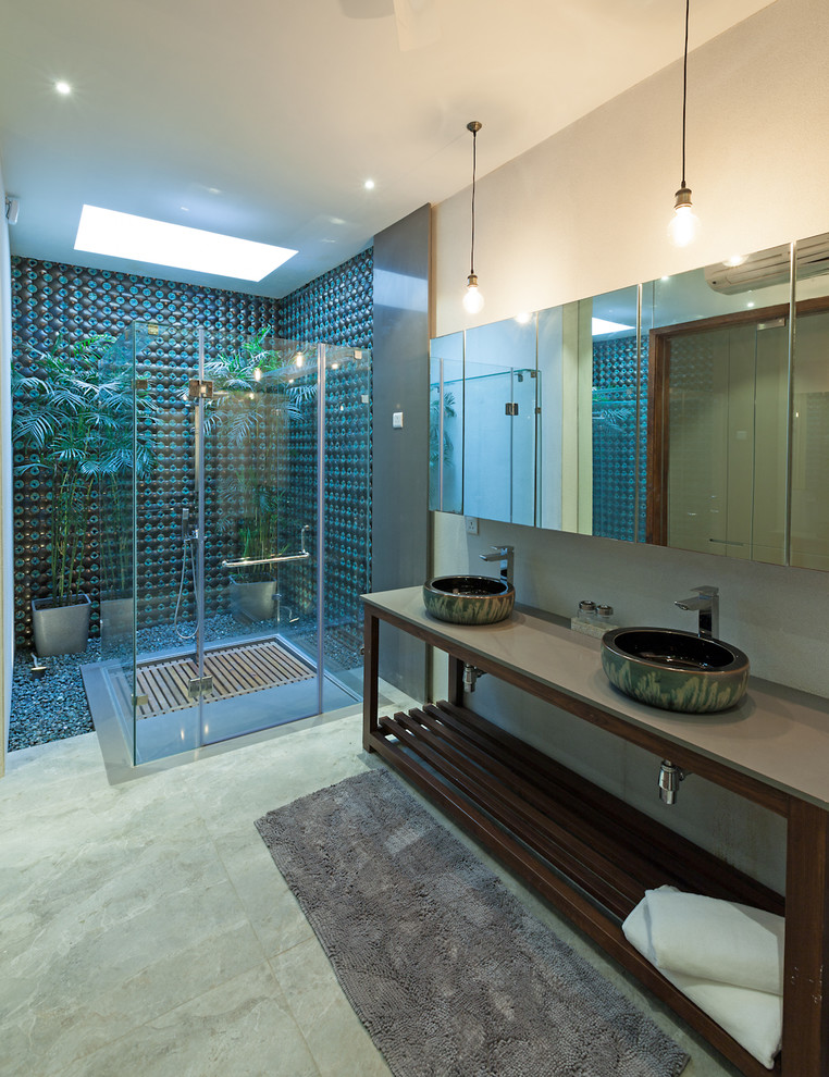 This is an example of a large contemporary bathroom in Delhi with a corner shower, marble flooring, a vessel sink, green floors, a hinged door and a feature wall.