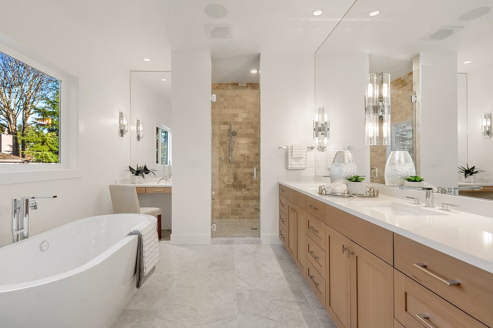 Exemple d'une salle de bain chic en bois brun avec un placard à porte shaker, une baignoire indépendante, un mur blanc, un lavabo encastré, un sol blanc et un plan de toilette blanc.