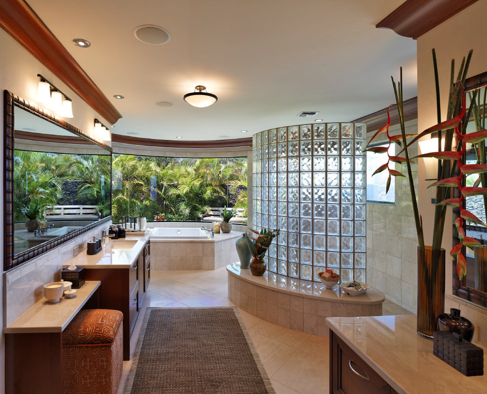 Large island style master beige tile and ceramic tile bathroom photo in Hawaii with recessed-panel cabinets, beige walls and an undermount sink