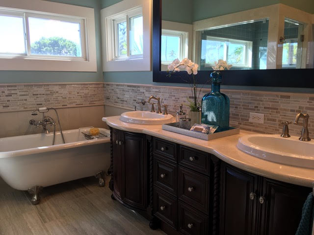 Design ideas for a large classic ensuite bathroom in Hawaii with raised-panel cabinets, dark wood cabinets, a claw-foot bath, grey tiles, ceramic tiles, blue walls, ceramic flooring, a built-in sink, laminate worktops and grey floors.