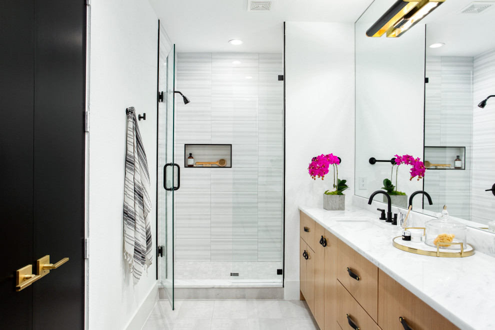 Inspiration for a scandinavian 3/4 white tile white floor and double-sink alcove shower remodel in Dallas with flat-panel cabinets, light wood cabinets, white walls, an undermount sink, a hinged shower door, white countertops, a niche and a built-in vanity