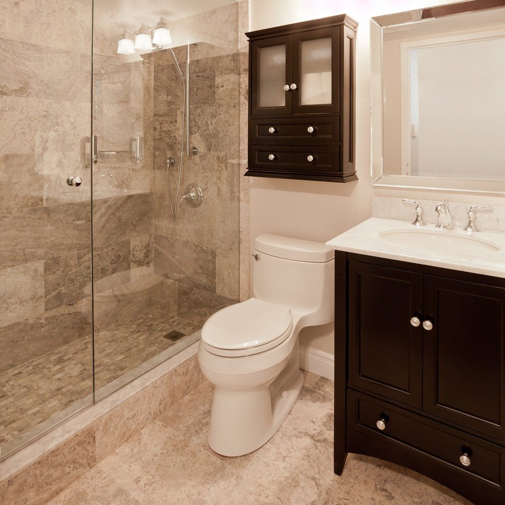 Example of a mid-sized transitional beige tile and porcelain tile porcelain tile alcove shower design in Phoenix with shaker cabinets, dark wood cabinets, a two-piece toilet, white walls and an undermount sink