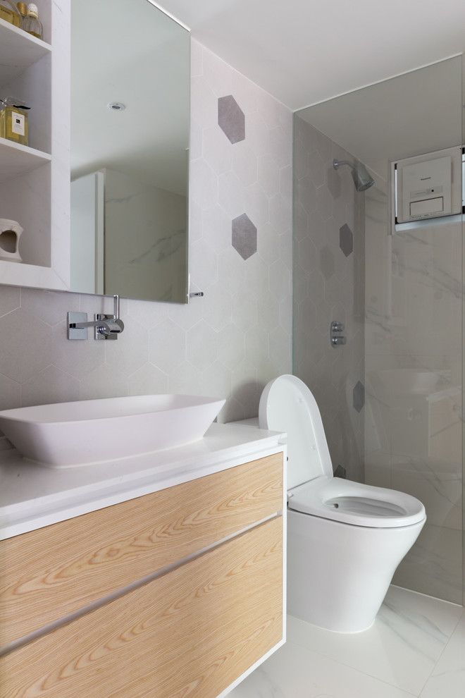 Example of a small minimalist 3/4 white tile and ceramic tile marble floor doorless shower design in Hong Kong with flat-panel cabinets, light wood cabinets, a one-piece toilet, white walls, a wall-mount sink and marble countertops