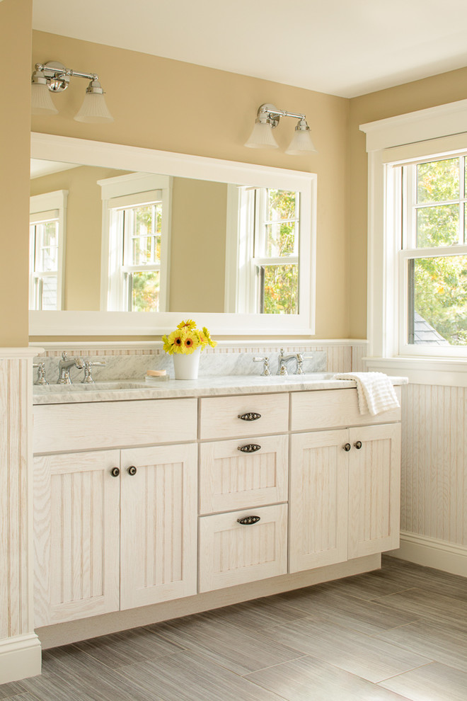 На фото: ванная комната в морском стиле с белыми фасадами, фасадами с филенкой типа жалюзи, желтыми стенами, врезной раковиной, серым полом и серой столешницей с