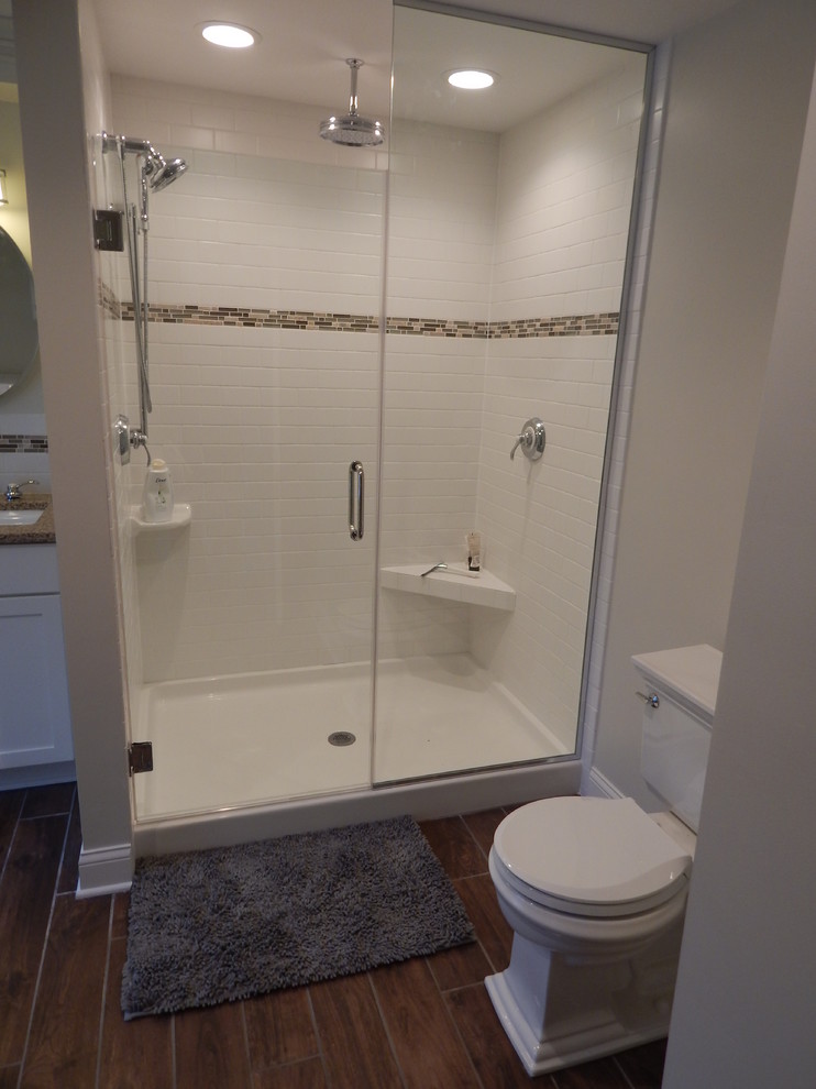 Medium sized traditional ensuite bathroom in Milwaukee with flat-panel cabinets, white cabinets, a double shower, a two-piece toilet, white tiles, ceramic tiles, white walls, ceramic flooring, a submerged sink and granite worktops.