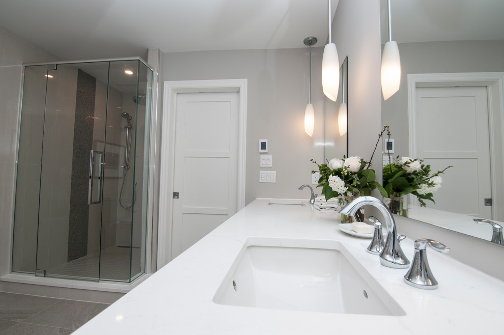 This is an example of a small contemporary ensuite bathroom in Ottawa with shaker cabinets, white cabinets, a freestanding bath, an alcove shower, white tiles, porcelain tiles, grey walls, a submerged sink, engineered stone worktops, a two-piece toilet, ceramic flooring, grey floors and a hinged door.
