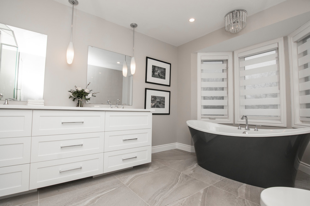 Inspiration for a small contemporary master white tile and porcelain tile ceramic tile and gray floor bathroom remodel in Ottawa with shaker cabinets, white cabinets, a two-piece toilet, gray walls, an undermount sink, quartz countertops and a hinged shower door