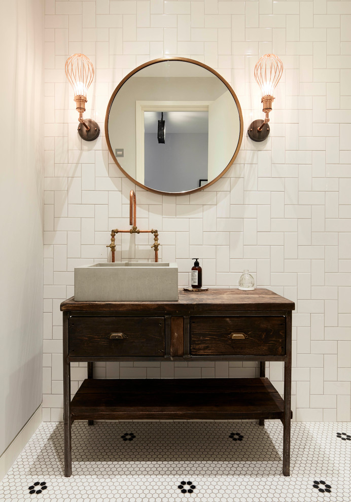 Urban bathroom in New York with freestanding cabinets, distressed cabinets, white tiles, porcelain tiles, white walls, mosaic tile flooring, a vessel sink, wooden worktops and white floors.