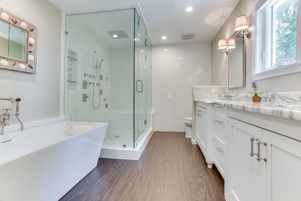 Inspiration for a large timeless master glass tile dark wood floor bathroom remodel in DC Metro with shaker cabinets, white cabinets, a two-piece toilet, white walls, an undermount sink, marble countertops and a hinged shower door
