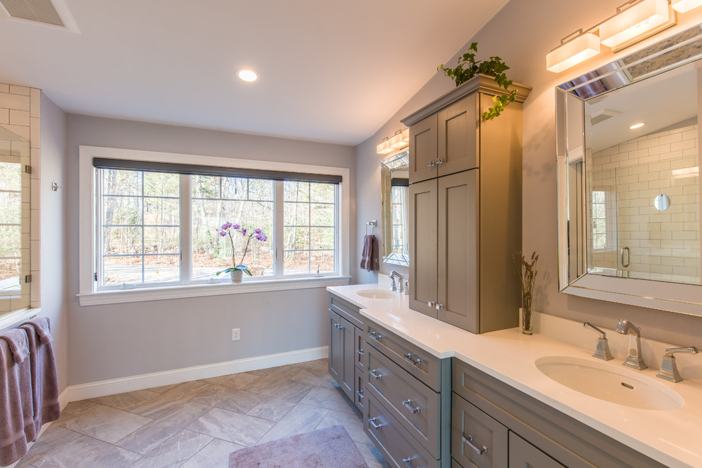 Double shower - mid-sized craftsman master white tile and subway tile porcelain tile double shower idea in Portland Maine with shaker cabinets, brown cabinets, a two-piece toilet, white walls, an undermount sink and solid surface countertops
