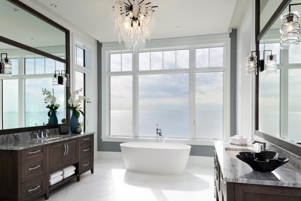 Inspiration för ett stort vintage grå grått en-suite badrum, med luckor med infälld panel, ett fristående badkar, grå väggar, marmorgolv, ett undermonterad handfat, granitbänkskiva, vitt golv och bruna skåp
