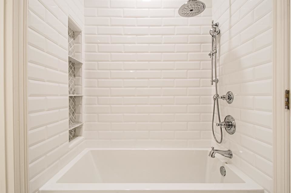 Klassisk inredning av ett mellanstort badrum för barn, med luckor med upphöjd panel, vita skåp, ett badkar i en alkov, vit kakel, porslinskakel, grå väggar, klinkergolv i porslin och bänkskiva i kvarts