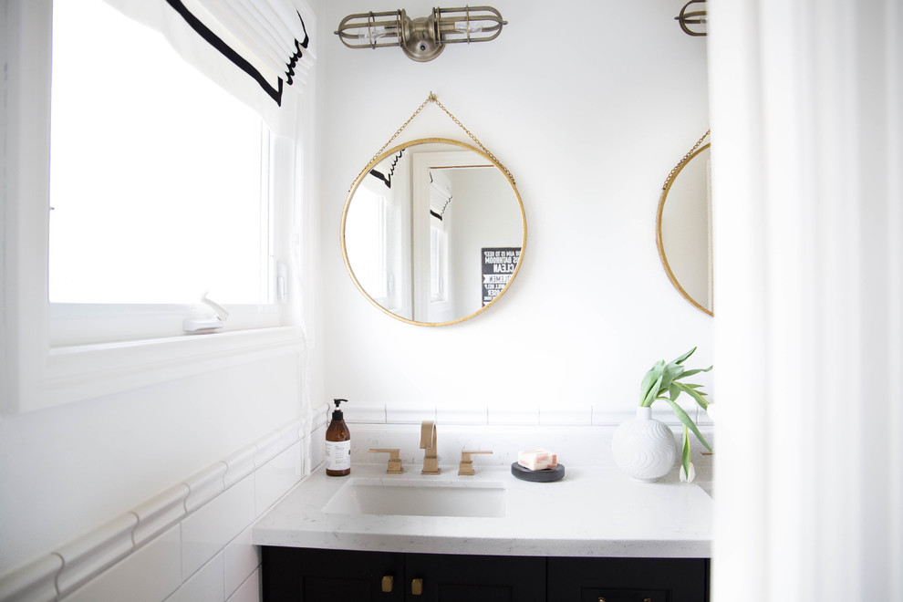 Small classic family bathroom in Toronto with shaker cabinets, black cabinets, a shower/bath combination, a one-piece toilet, white tiles, metro tiles, white walls, mosaic tile flooring, engineered stone worktops, white floors and a shower curtain.