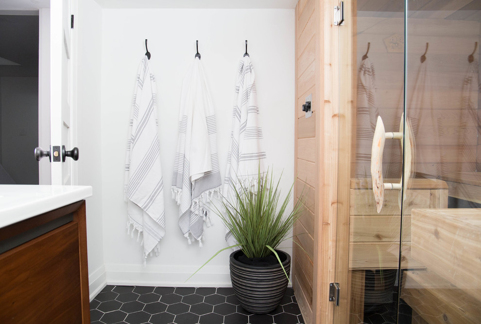 Inspiration for a small modern sauna bathroom in Toronto with flat-panel cabinets, medium wood cabinets, an alcove shower, a one-piece toilet, white walls, ceramic flooring, an integrated sink, engineered stone worktops, black floors and an open shower.