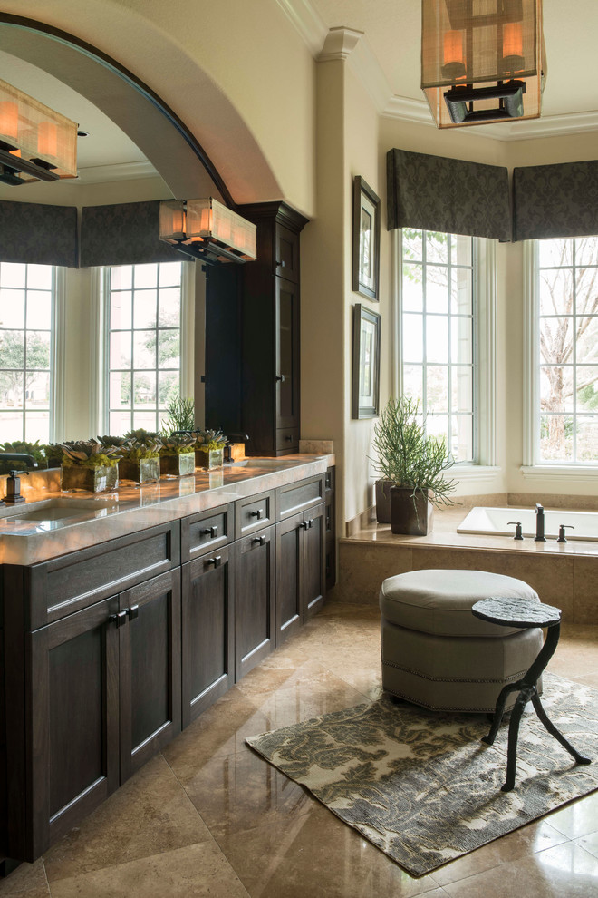 Inspiration for a transitional master drop-in bathtub remodel in Orlando with an undermount sink, shaker cabinets, dark wood cabinets and beige walls