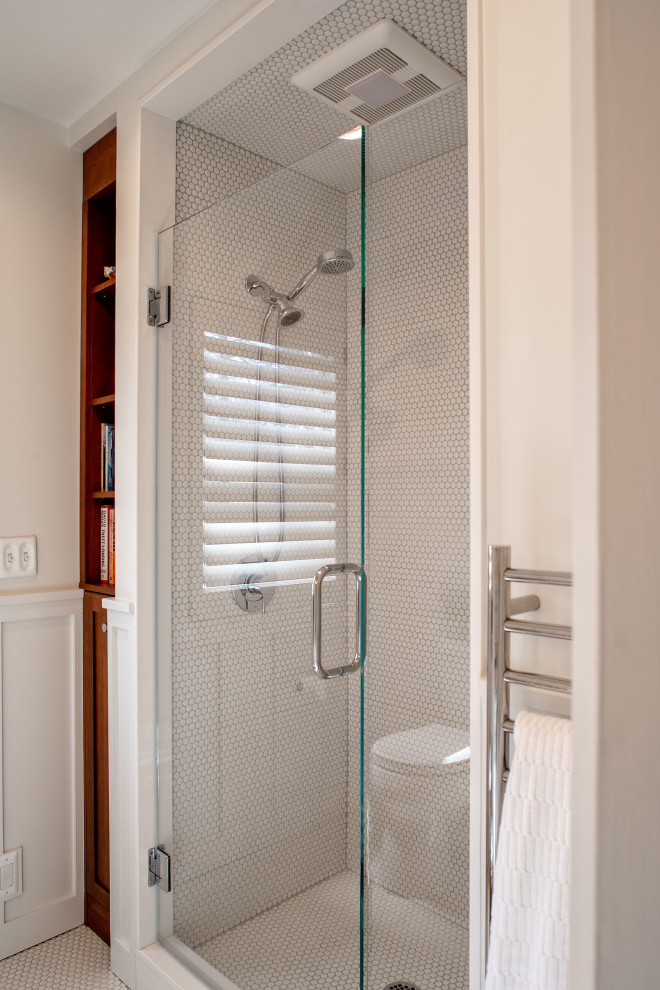 Photo of a medium sized classic shower room bathroom in Detroit with white cabinets, an alcove shower, a two-piece toilet, white tiles, mosaic tiles, white walls, mosaic tile flooring, a pedestal sink, white floors, a hinged door, a single sink, a freestanding vanity unit and wainscoting.