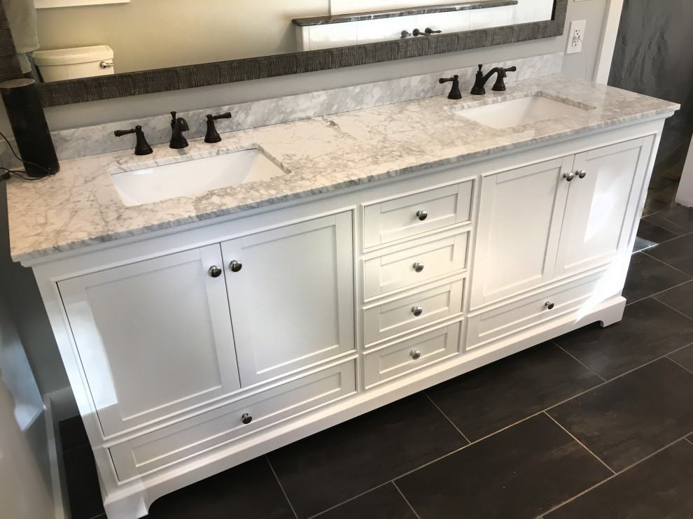 Design ideas for a large traditional ensuite bathroom in Atlanta with shaker cabinets, white cabinets, a freestanding bath, a double shower, white tiles, ceramic tiles, a built-in sink, granite worktops, a hinged door and white worktops.