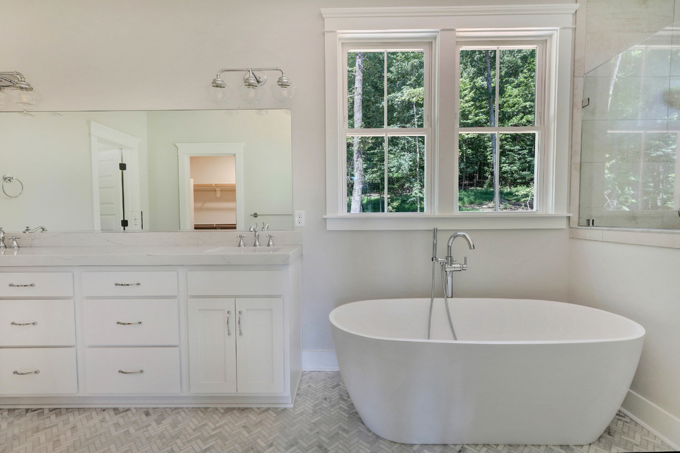 Transitional marble floor bathroom photo in Richmond with shaker cabinets, white cabinets, gray walls, an undermount sink, marble countertops, a hinged shower door and white countertops