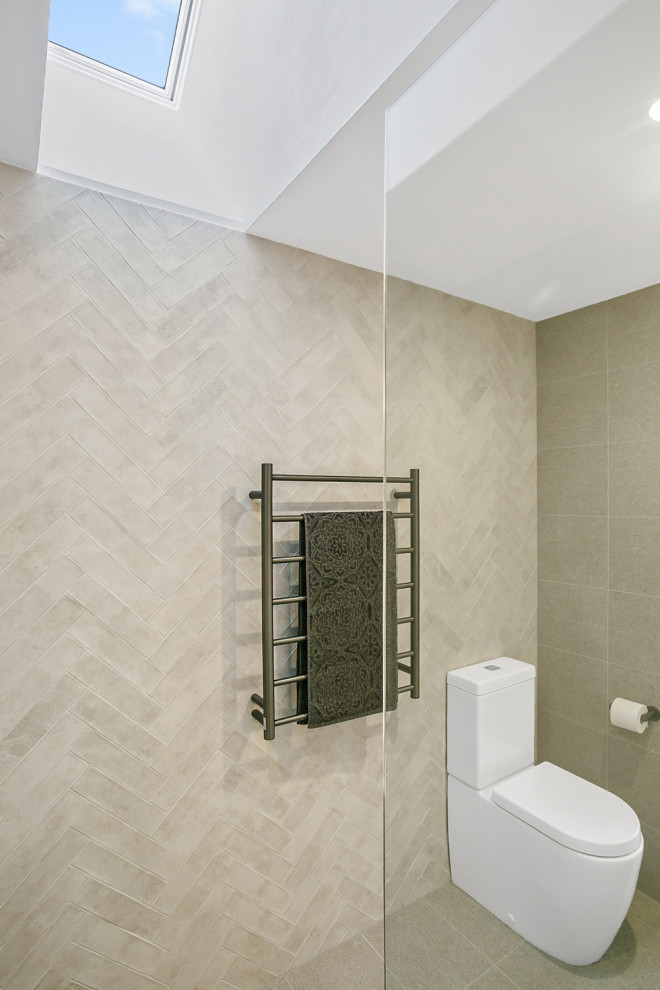 Design ideas for a medium sized contemporary bathroom in Sydney with medium wood cabinets, a walk-in shower, beige tiles, porcelain tiles, beige walls, porcelain flooring, a vessel sink, engineered stone worktops, beige floors, an open shower and white worktops.
