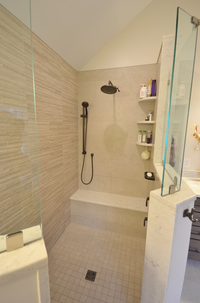 This is an example of a large classic ensuite bathroom in Philadelphia with raised-panel cabinets, brown cabinets, a walk-in shower, a one-piece toilet, beige tiles, ceramic tiles, white walls, ceramic flooring, a submerged sink, granite worktops, beige floors, an open shower and white worktops.