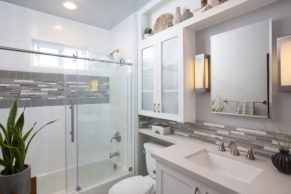 Example of a mid-sized trendy kids' white tile, gray tile and matchstick tile white floor and mosaic tile floor bathroom design in Denver with shaker cabinets, white cabinets, quartz countertops, a one-piece toilet, gray walls and an undermount sink