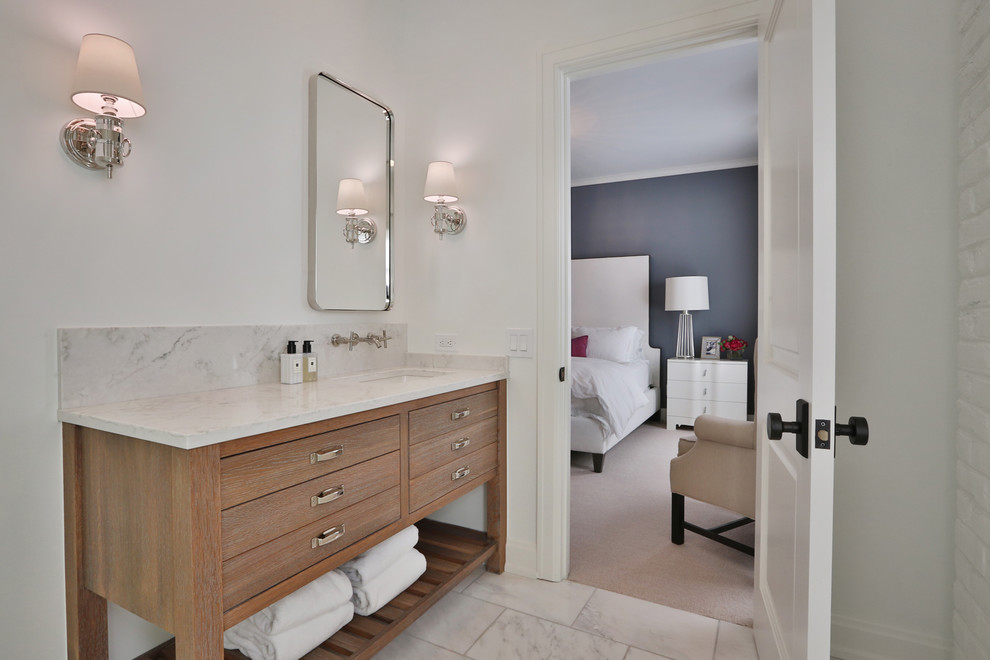 Corner shower - mid-sized transitional kids' white tile and marble tile white floor corner shower idea in Columbus with flat-panel cabinets, light wood cabinets, a one-piece toilet, white walls, an undermount sink, marble countertops, a hinged shower door and white countertops