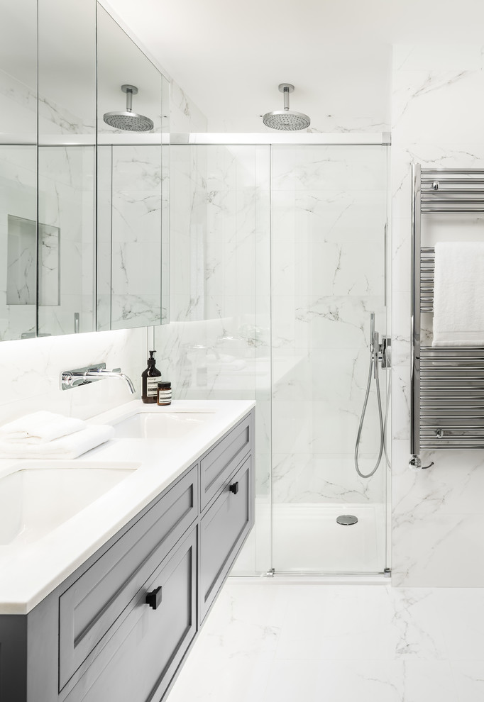 This is an example of a medium sized contemporary bathroom in London with recessed-panel cabinets, grey cabinets, marble tiles, white walls, marble flooring, white floors and a hinged door.