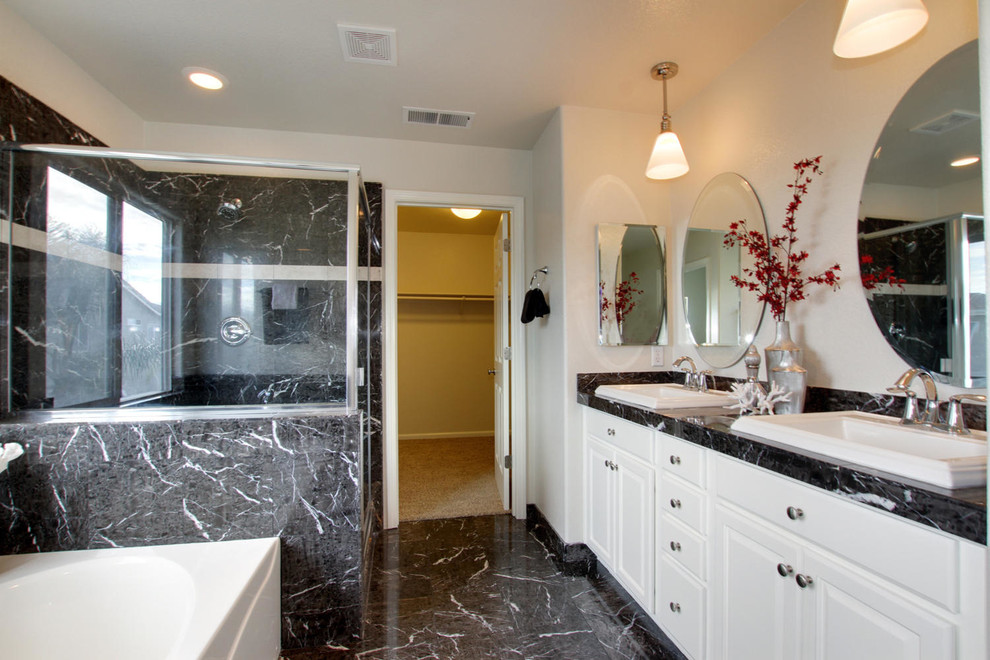 Bathroom - traditional black tile bathroom idea in Sacramento with a vessel sink, raised-panel cabinets, white cabinets and marble countertops