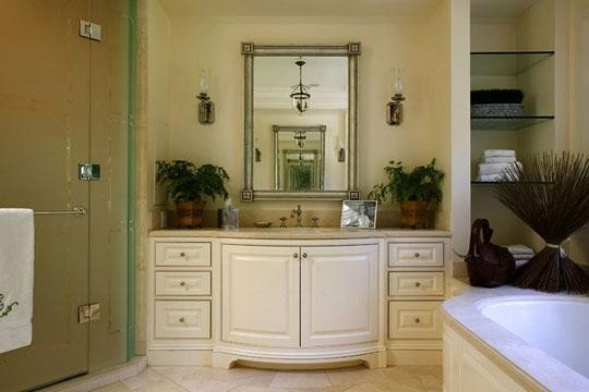 Corner shower - large traditional master travertine floor and beige floor corner shower idea in San Francisco with beaded inset cabinets, white cabinets, an undermount tub, beige walls and a hinged shower door