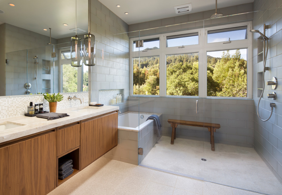 Contemporary ensuite bathroom in San Francisco with a submerged sink, flat-panel cabinets, medium wood cabinets, solid surface worktops, a walk-in shower, grey walls and ceramic flooring.