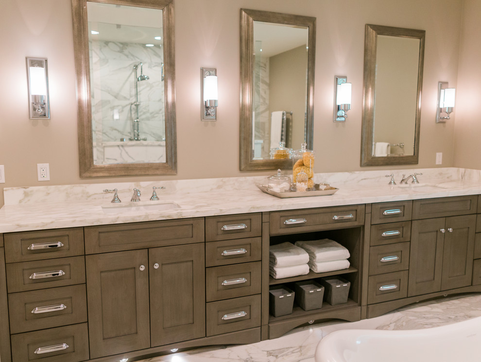 Photo of a large classic ensuite bathroom in San Francisco with shaker cabinets, grey cabinets, a freestanding bath, a walk-in shower, white tiles, stone tiles, grey walls, marble flooring, a submerged sink, marble worktops and a two-piece toilet.