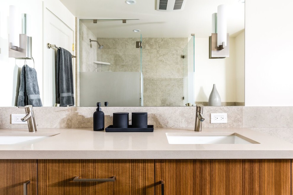 Medium sized contemporary shower room bathroom in San Francisco with flat-panel cabinets, medium wood cabinets, a double shower, a two-piece toilet, beige tiles, marble tiles, white walls, porcelain flooring, a submerged sink, engineered stone worktops, black floors and a hinged door.