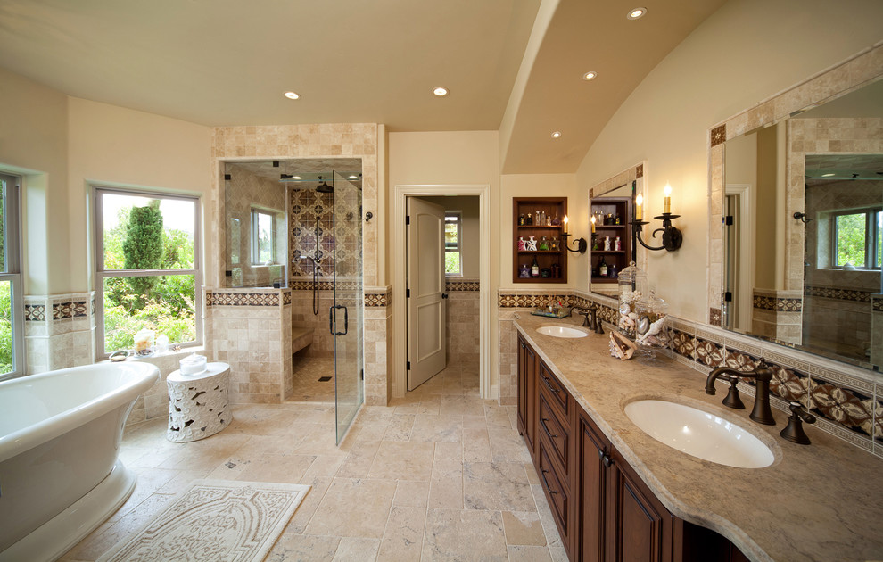 Bathroom - large traditional master beige tile and ceramic tile ceramic tile and beige floor bathroom idea in San Luis Obispo with raised-panel cabinets, dark wood cabinets, beige walls, an undermount sink, granite countertops and a hinged shower door