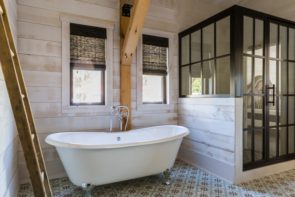 Farmhouse bathroom in Raleigh with a claw-foot bath, a corner shower, beige walls, multi-coloured floors, a hinged door and wood walls.