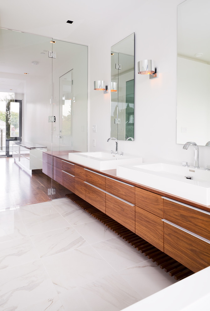 Design ideas for a contemporary bathroom in Vancouver with a vessel sink, flat-panel cabinets and medium wood cabinets.