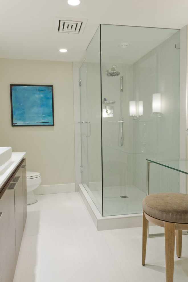 Small trendy master corner shower photo in Vancouver with flat-panel cabinets, medium tone wood cabinets, quartz countertops, a one-piece toilet and gray walls