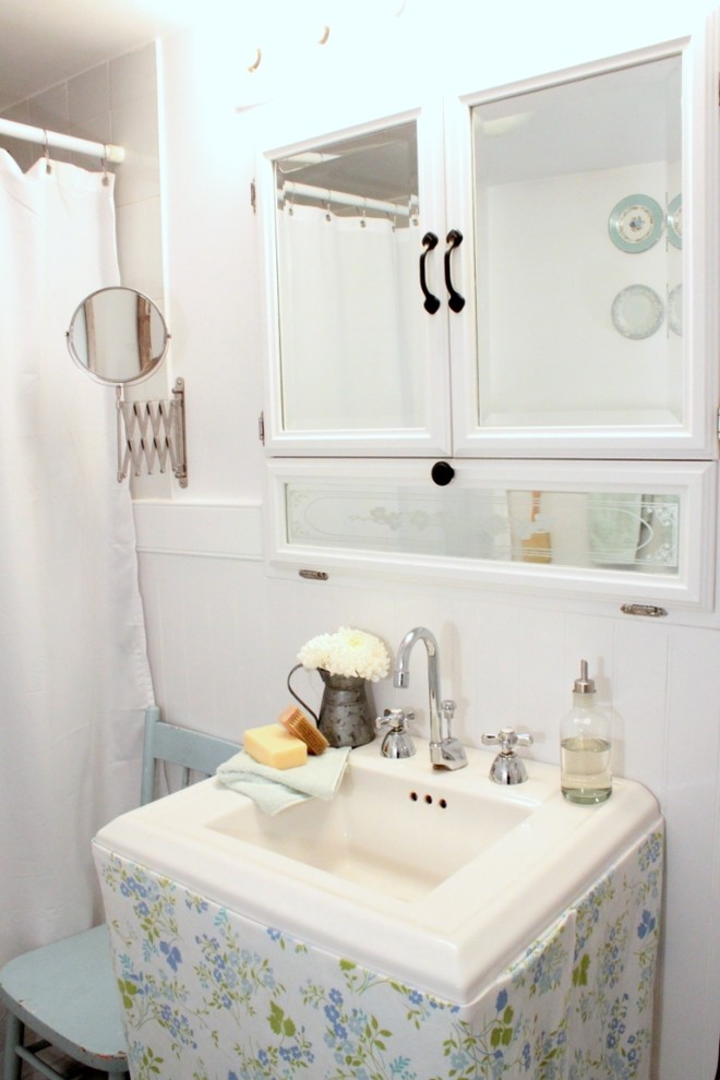 Design ideas for a shabby-chic style bathroom in Toronto with an integrated sink and white cabinets.