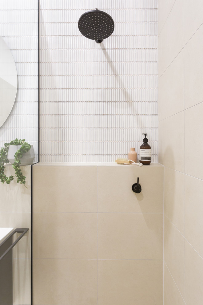 Photo of a medium sized modern shower room bathroom in Melbourne with beaded cabinets, black cabinets, a walk-in shower, cement tiles, a vessel sink, stainless steel worktops and white worktops.