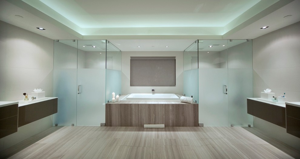 Inspiration for a large modern master light wood floor corner shower remodel in Miami with dark wood cabinets, marble countertops, an undermount tub and beige walls