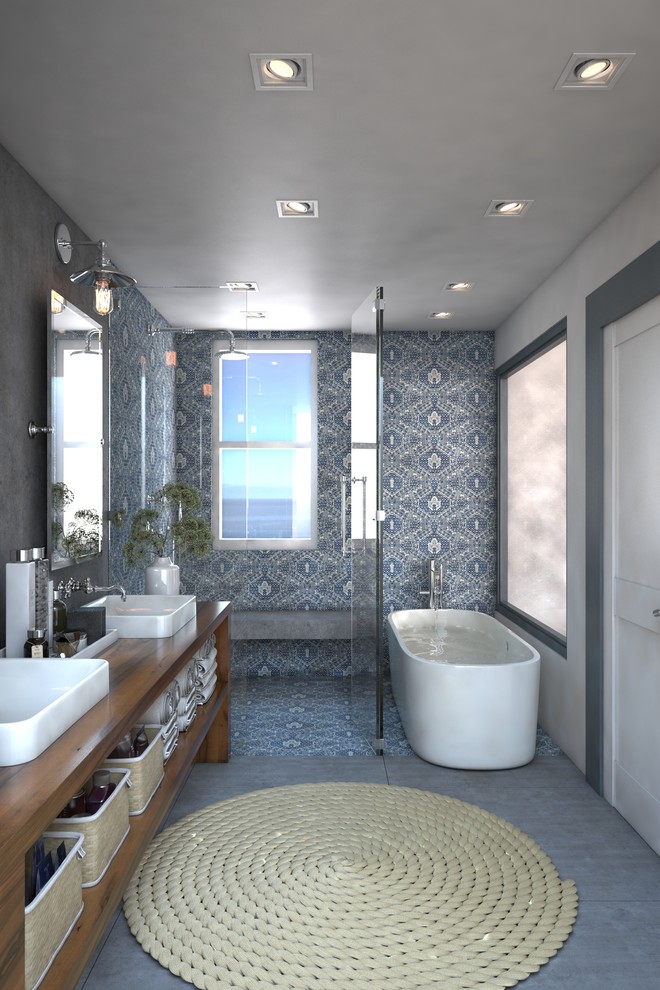 Example of a large beach style master gray tile and cement tile ceramic tile bathroom design in Miami with open cabinets, medium tone wood cabinets, a one-piece toilet, white walls, a vessel sink and wood countertops