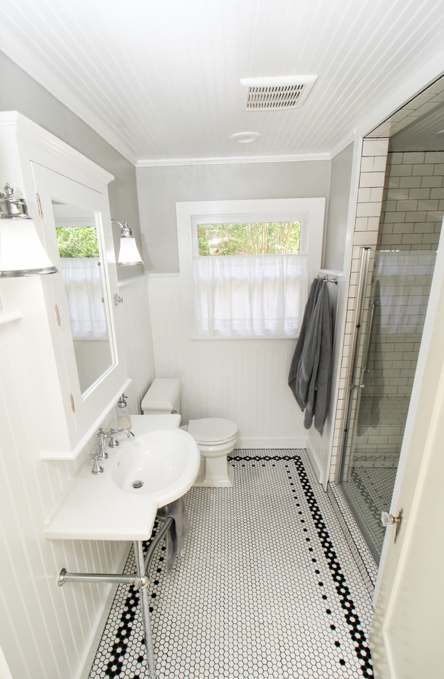 Alcove shower - small country 3/4 white tile and subway tile mosaic tile floor and white floor alcove shower idea in Houston with shaker cabinets, white cabinets, a two-piece toilet, gray walls, a pedestal sink and a hinged shower door