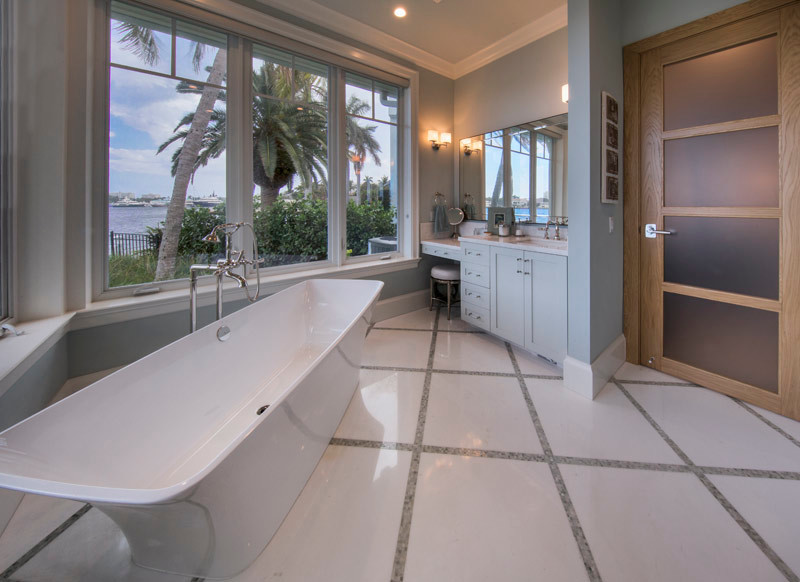 Expansive world-inspired ensuite bathroom in Miami with white tiles and blue walls.